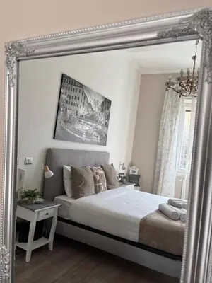 a large mirror in a bedroom with a bed at Sweet Anna in Rome