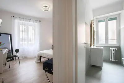 a white room with a bed and a room with a window at Monte Sacro apartment for 6 guests Metro B in Rome