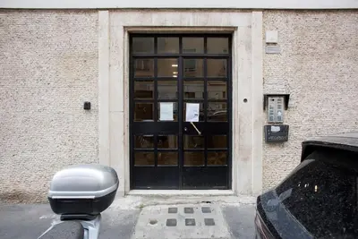 a parking meter in front of a door of a building at Monte Sacro apartment for 6 guests Metro B in Rome