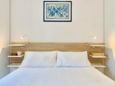 a bedroom with a bed with two lights above it at RomeAsYouLike - Stradivari Charme in Rome