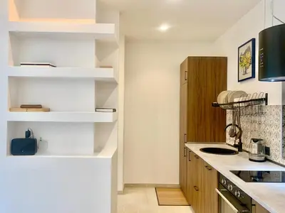 a kitchen with white shelves and a counter top at RomeAsYouLike - Stradivari Charme in Rome