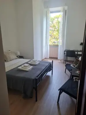 a room with a bed and a table with towels on it at testaccio sei in Rome