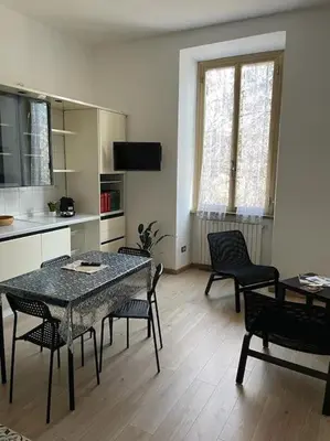 a kitchen with a table and chairs in a room at testaccio sei in Rome