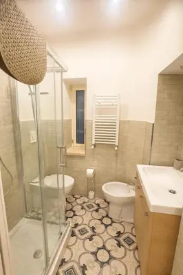 a bathroom with a shower and a toilet and a sink at FL Suites - Vatican in Rome