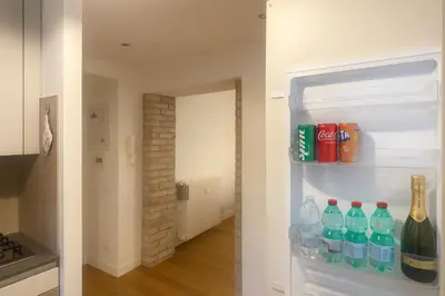 an open refrigerator filled with bottles of water and soda at FL Suites - Vatican in Rome