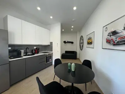 a kitchen and dining room with a table and chairs at Chic&Elegant Retreat in Rome in Rome