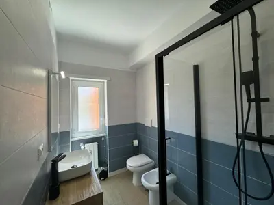 a bathroom with a white toilet and a sink at Chic&Elegant Retreat in Rome in Rome