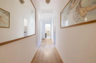 a hallway with two large paintings on the walls at Elegant Ostiense Suite in Rome