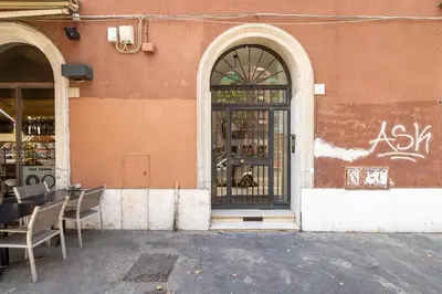 an entrance to a restaurant with a glass door at Elegant Ostiense Suite in Rome