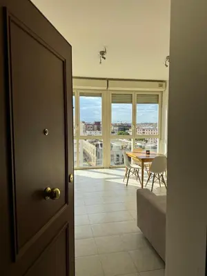 a room with a table and a dining room with a view at Bright apt near Porta Maggiore in Rome