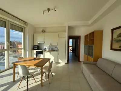 a living room with a table and a couch at Bright apt near Porta Maggiore in Rome