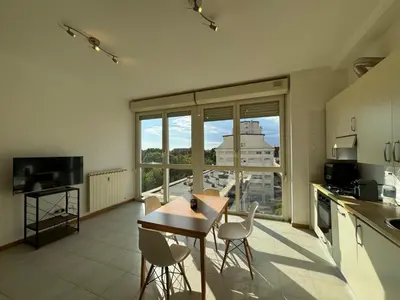 a kitchen with a table and chairs and a large window at Bright apt near Porta Maggiore in Rome
