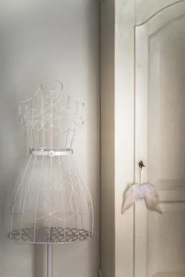 a white dress holder next to a door at Vatican Angels Casa Vacanze in Rome
