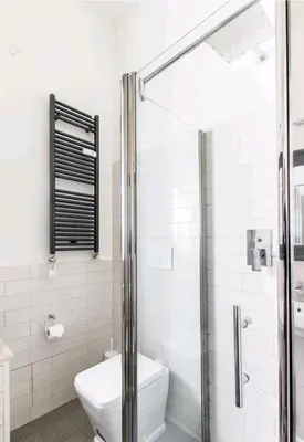 a bathroom with a toilet and a glass shower at Vatican Angels Casa Vacanze in Rome