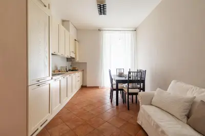 a kitchen and dining room with a couch and a table at Centro - casa a Trastevere in Rome