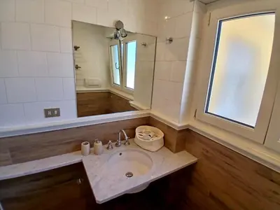 a bathroom with a sink and a large mirror at Luce, Silenzio ed Eleganza nel Cuore di Roma - 2 camere da letto in Rome