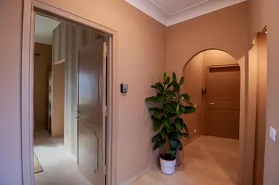a hallway with a door and a potted plant at Boutique Suites Valadier in Rome