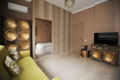 a living room with a yellow couch and a mirror at Boutique Suites Valadier in Rome