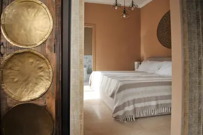 a bedroom with a bed and two mirrors on the wall at Boutique Suites Valadier in Rome