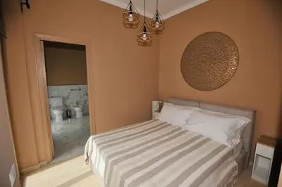 a bedroom with a bed and a bathroom with a toilet at Boutique Suites Valadier in Rome
