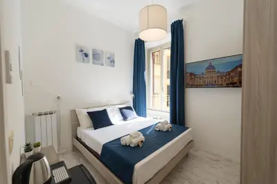 a bedroom with a bed with two stuffed animals on it at Barletta Vatican Rooms in Rome