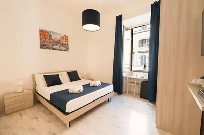 a bedroom with a bed and a window at Barletta Vatican Rooms in Rome