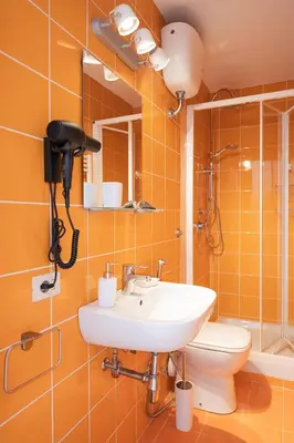 a bathroom with a sink and a toilet at Barletta Vatican Rooms in Rome