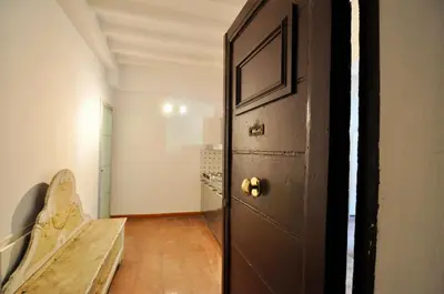 a hallway with a door and a bench in a room at Pantheon Suite in Rome