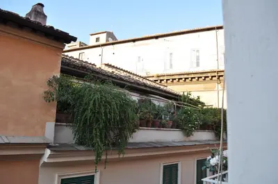 a balcony with potted plants on the side of a building at Pantheon Suite in Rome