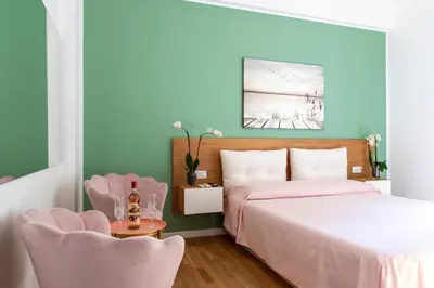 a bedroom with a bed and two chairs at ToniB&B in Rome