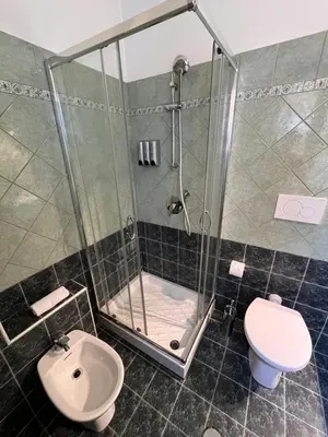 a bathroom with a shower and a toilet at Cortile San Tommaso in Rome