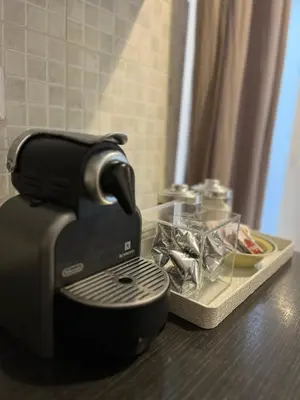 a coffee maker sitting on a counter next to a plate of food at Cortile San Tommaso in Rome