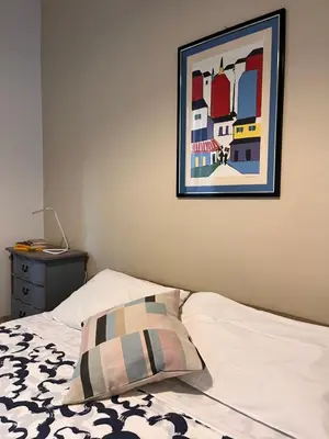 a bed with a pillow and a picture on the wall at Cortile San Tommaso in Rome