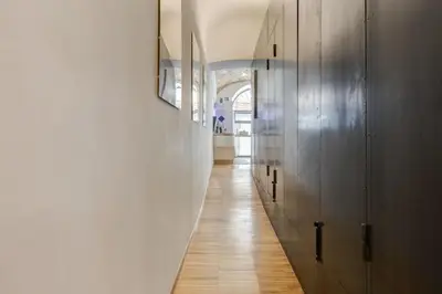 a hallway with wooden floors and a white wall at L'atelier in Rome