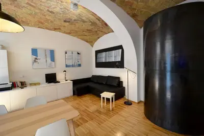 a living room with a black couch and a table at L'atelier in Rome