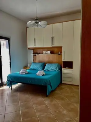 a bedroom with a blue bed in a room at Rione Testaccio Apartment in Rome