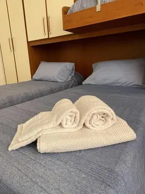 a pair of towels sitting on top of a bed at Rione Testaccio Apartment in Rome