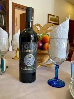 a bottle of wine sitting next to a wine glass at Rione Testaccio Apartment in Rome