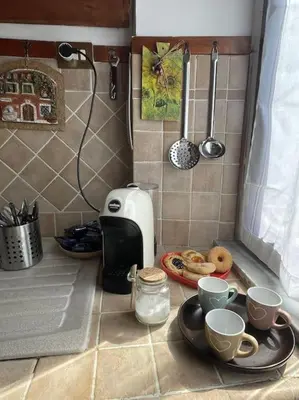 a kitchen counter with cups of coffee and donuts at Rione Testaccio Apartment in Rome