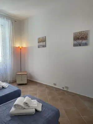 a room with two beds with towels on them at Rione Testaccio Apartment in Rome
