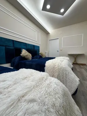 a bedroom with two beds and a large white blanket at Glint House Prestige in Rome