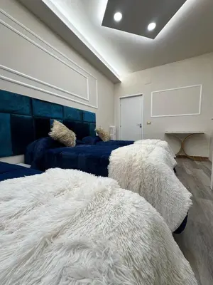 a bedroom with two beds with white blankets at Glint House Prestige in Rome