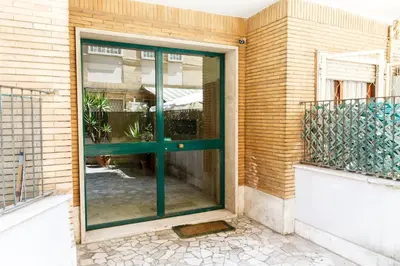 a green door on the side of a building at Maison Chic Cornelia - San Pietro in Rome