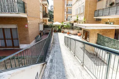a walkway in the middle of a city with buildings at Maison Chic Cornelia - San Pietro in Rome