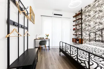 a bedroom with a bed and a desk at Maison Chic Cornelia - San Pietro in Rome