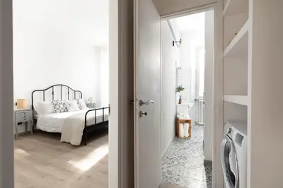 a bedroom with a bed and a door leading to a bathroom at Loving Testaccio in Rome