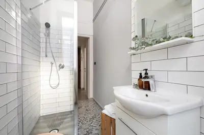 a white bathroom with a sink and a shower at Loving Testaccio in Rome