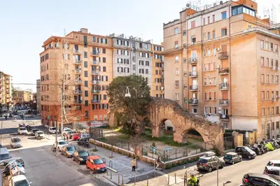 a city street with cars parked in front of buildings at Loving Testaccio in Rome