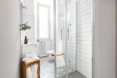 a bathroom with a toilet and a glass shower at Loving Testaccio in Rome