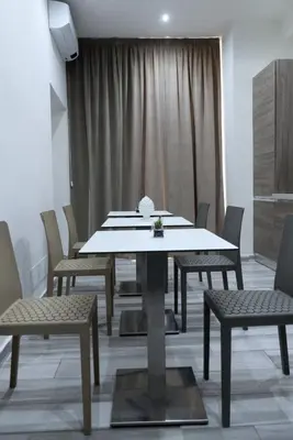 a dining room with a table and chairs at Le Stanze di Elisa in Rome